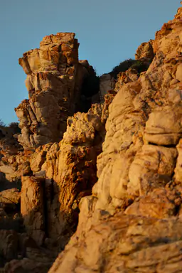 Sunlit granite and Mediterranean water.